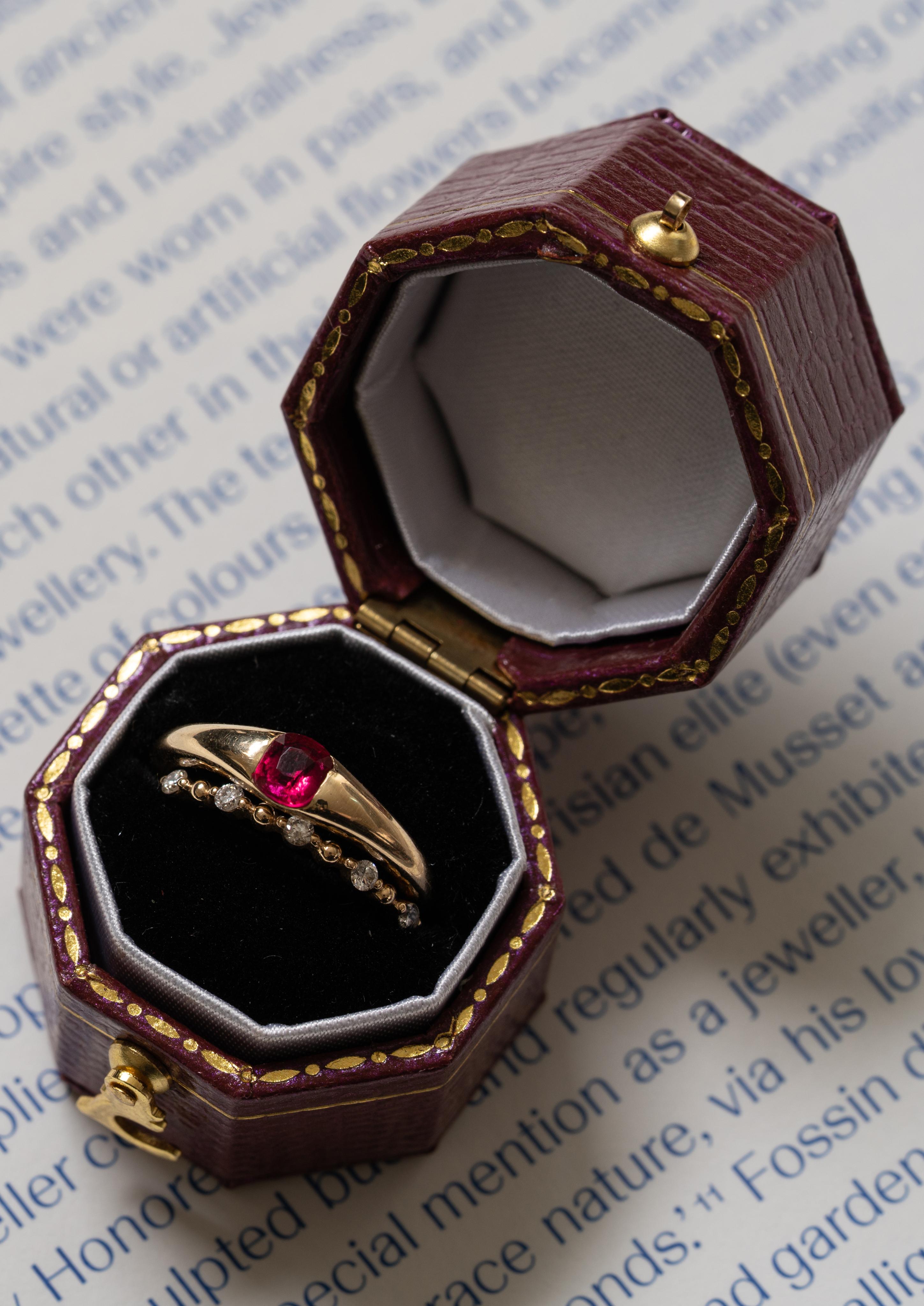 Woman in a suit, holding a flower, bathed in warm light